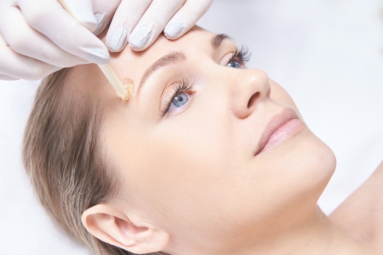 Beautician Grooming the Client's Brow  